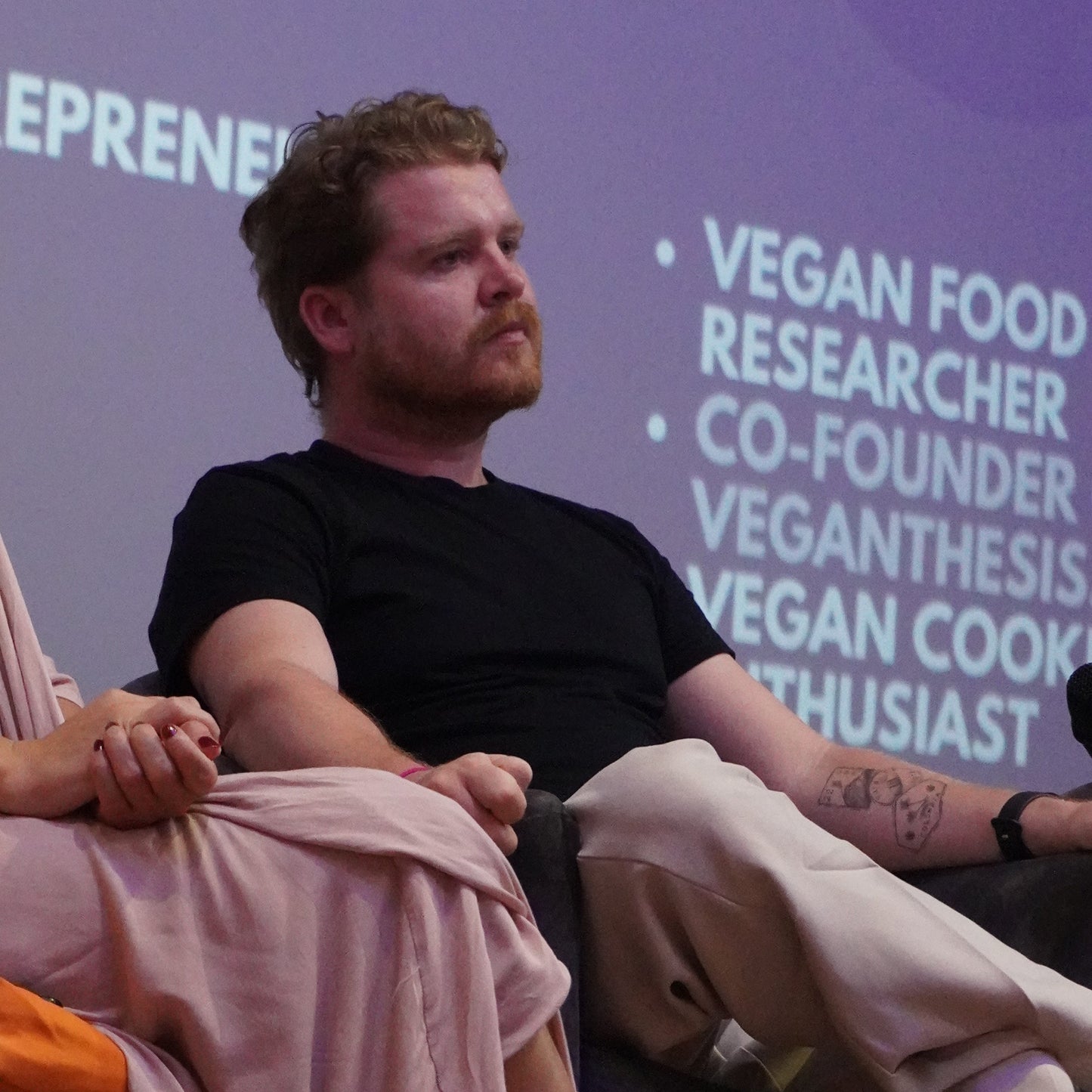 Callum Weir, vegan nutritionist, sitting at conference