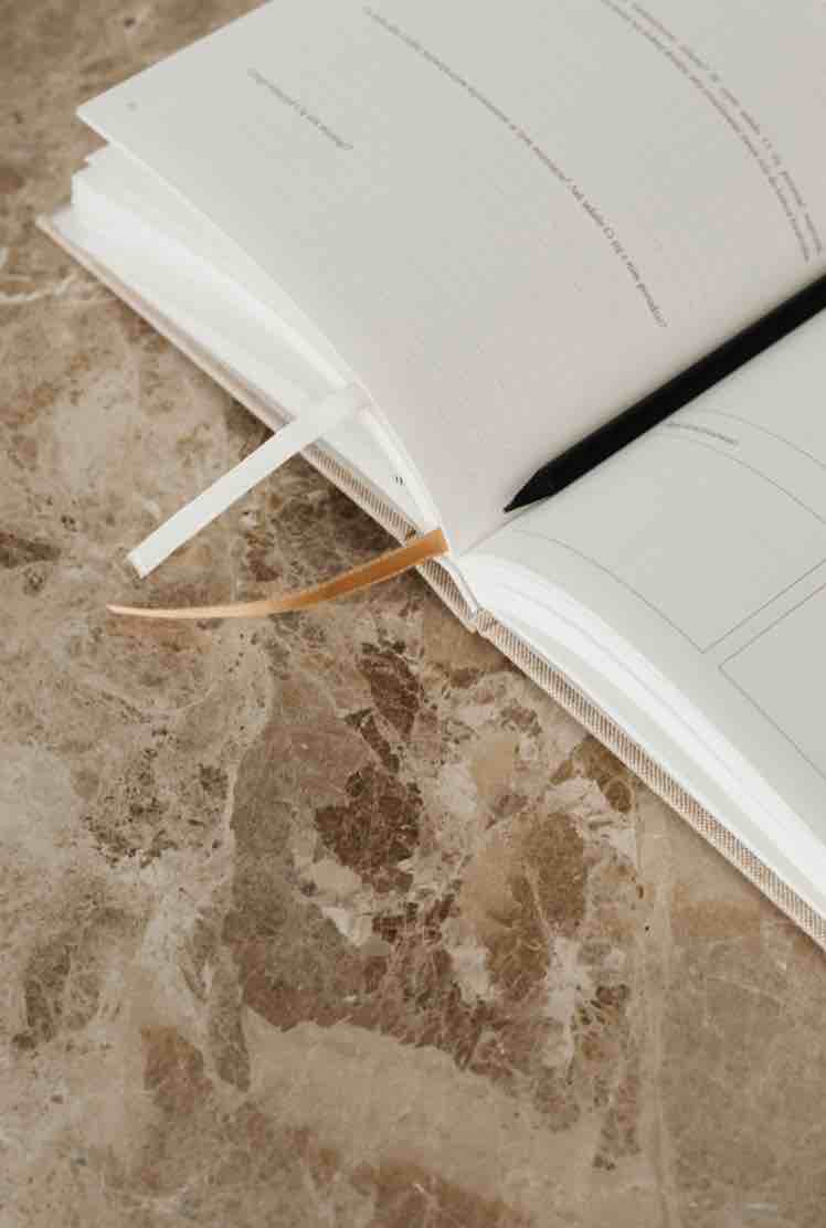 Open book with a bookmark on a textured surface